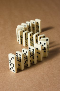 Dominoes on brown background clipart