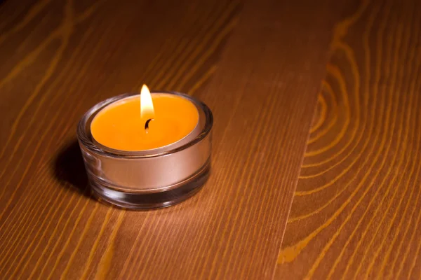 Candle on wooden table — Stock Photo, Image