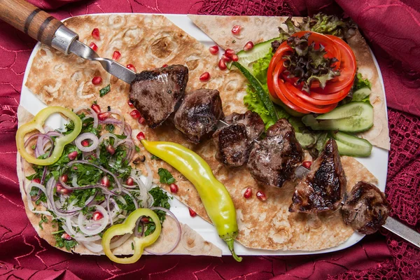 stock image Fried beef kebab on a skewer with vegetables