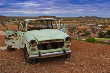 Rusty car in the australian outback clipart
