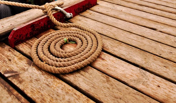 stock image Marine rope spiral on wooden deck