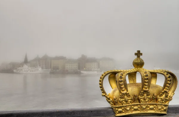Golden crown and city in mist. — Stock Photo, Image