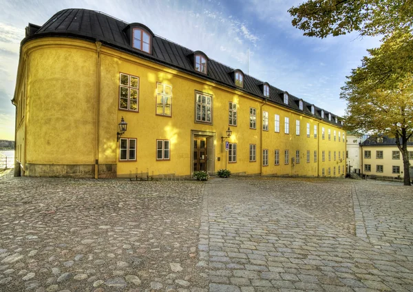 stock image Old yellow building on medieval square.