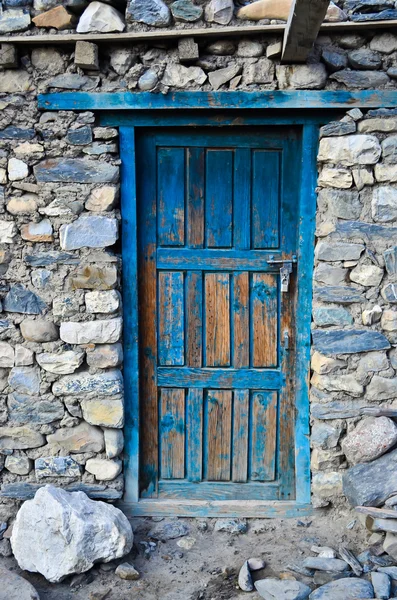Блакитні двері на кам'яній стіні — стокове фото