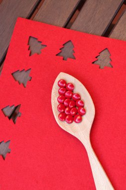 Wooden spoon with red candies