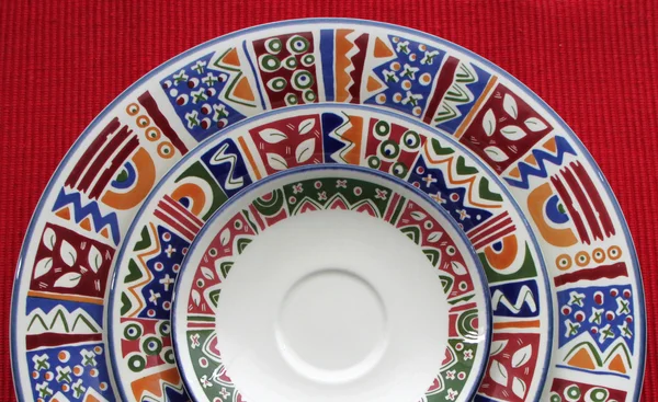 Colorful plates on red — Stock Photo, Image