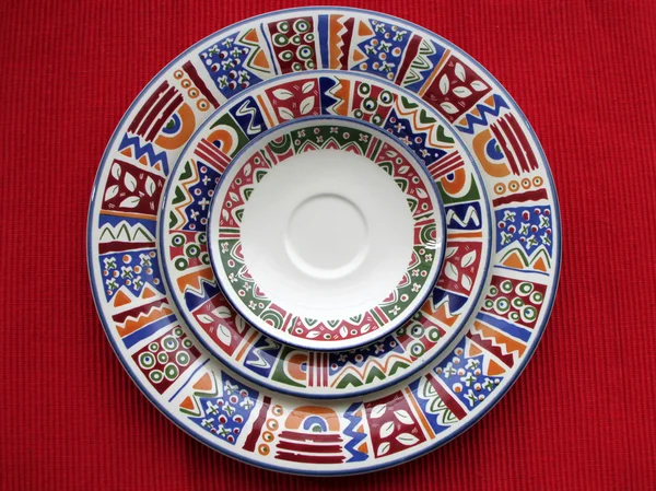 Colorful plates on red — Stock Photo, Image