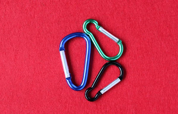 Three isolated blue, black and green karabiners/carabiners — Stock Photo, Image
