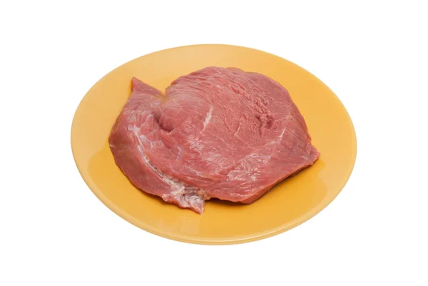 Pedaço de carne crua em uma chapa — Fotografia de Stock