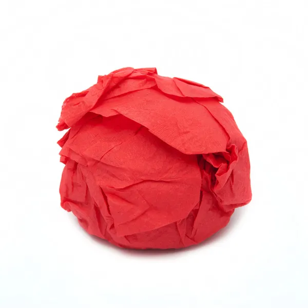 Algo redondo en un papel rojo — Foto de Stock