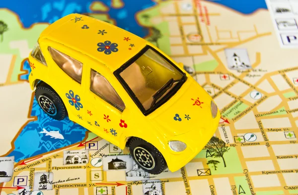 Yellow toy car on map — Stock Photo, Image