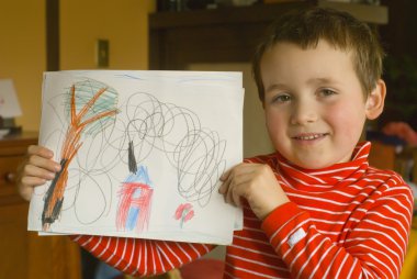 Proud boy holding his art work clipart