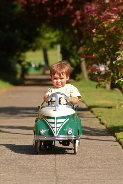 Boy driving pedal car — Stock Photo, Image