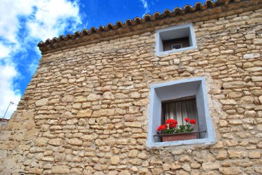 Pot in a window of a cottage in Fuendetodos clipart