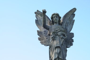 Statue of a stone cherubim angel in a cemetery in london, england clipart