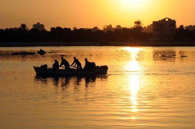 Fishermen in an egyptian lake clipart
