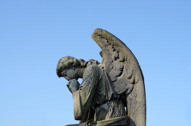 Statue of a stone cherubim, angel in a cemetery in london, england clipart
