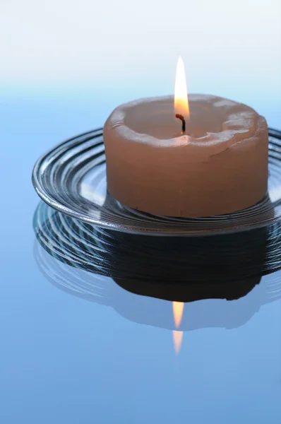 stock image Lit candle against blue background