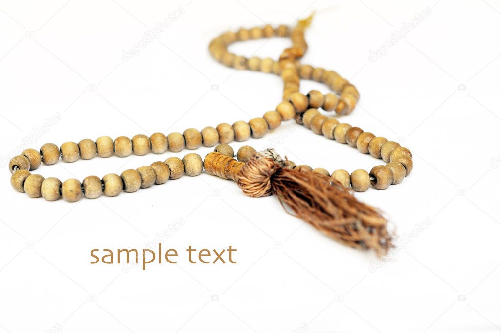 Close-up of prayer beads against white background