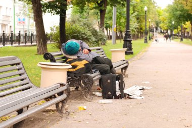 Drunk man on the park bench clipart