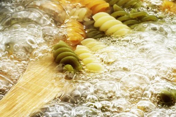 Spiral pasta in boiling hot water Stock Picture