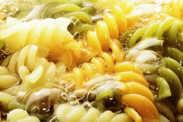 Spiral pasta in boiling hot water Stock Image