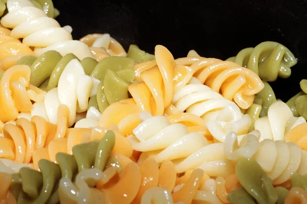 Spiral pasta in boiling hot water Stock Photo