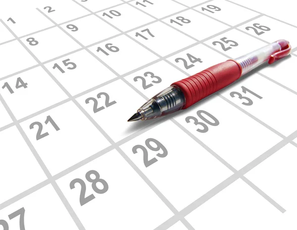 Roter Stift auf einem Kalender Stockfoto