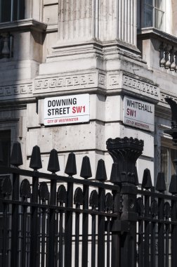 LONDON, UK - APRIL 02: Downing Street nameplate in the corner wi clipart