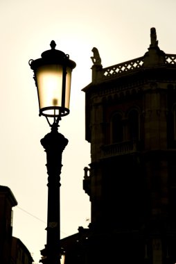 Late afternoon backlit lightpost in Padova clipart