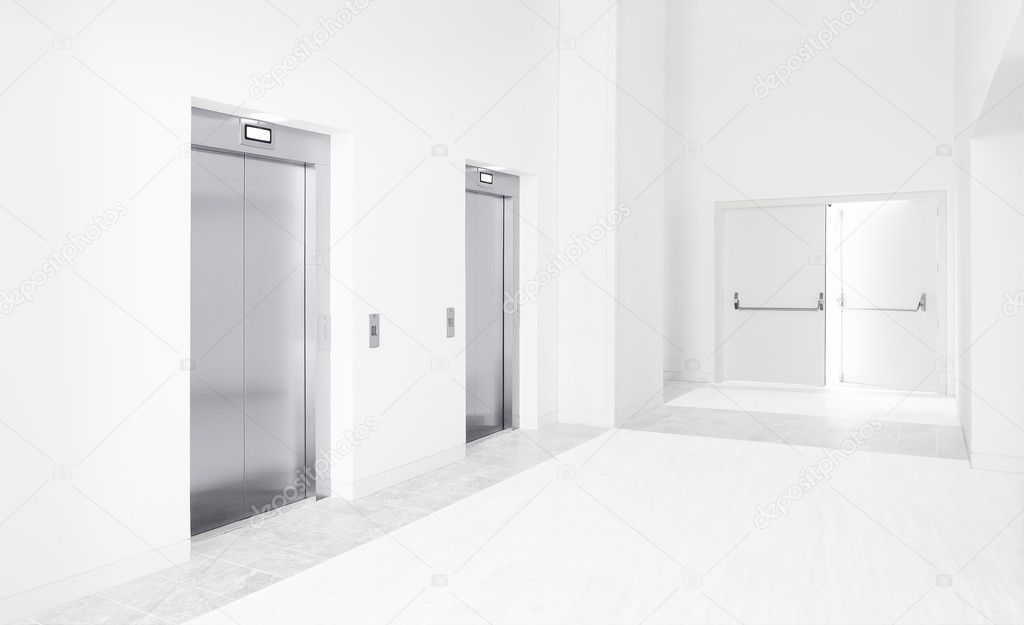 Two modern elevators and an open exit door
