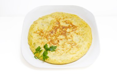 Slices of Spanish omelet or tortilla de patatas on a white plate clipart