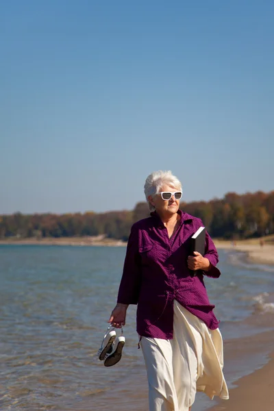 Senior Walking on the Beach Vertical — Stock Image Senior Walking on the Beach Vertical Royalty Free Stock Photos