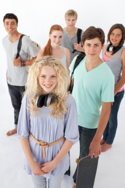 Happy teenagers smiling at the camera with bags clipart