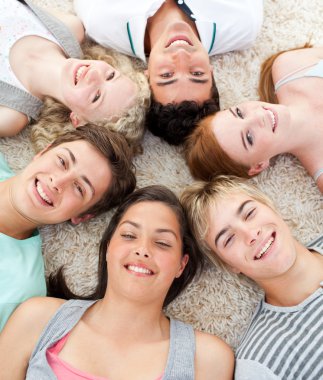 Teenagers with their heads together smiling clipart