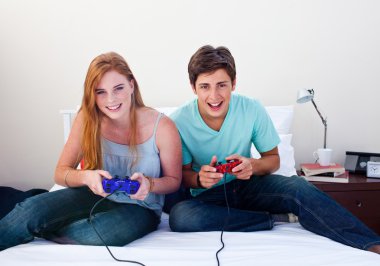 A couple of teenagers playing video games clipart