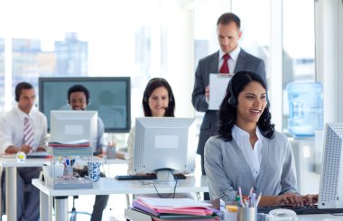 Supervisor taking notes in a call center clipart