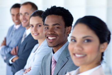 Attractive businessman in a row with his team clipart