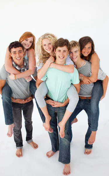 Teenagers giving their friends piggyback rides — Stock Photo, Image