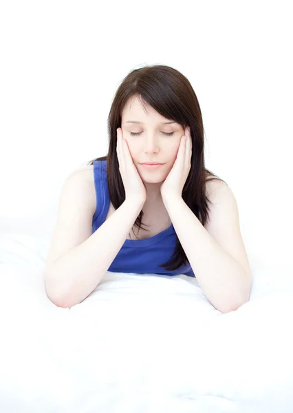 Tired woman sitting on her bed — Stock Photo, Image