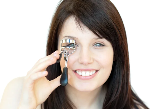 Charming teen girl using an eyelash curler — Stock Photo, Image