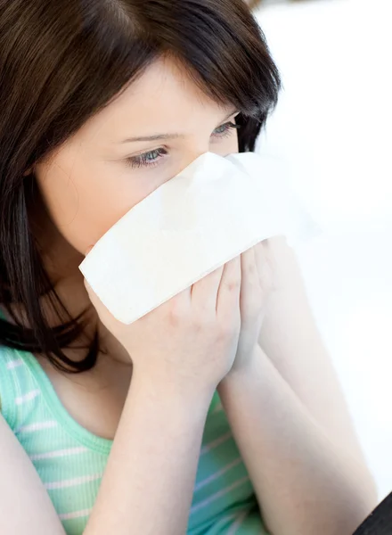 Portrait of a sick brunette teen girl blowing — Stock Photo, Image
