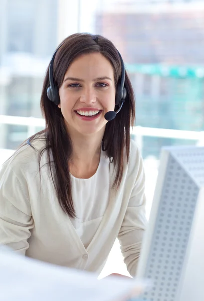 Portrait of a smiling businesswoman working in a call center — Stock Photo, Image