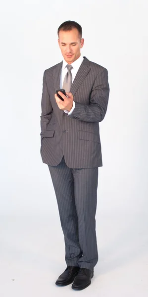 Isolated businessman writing a message with a mobile phone — Stock Photo, Image