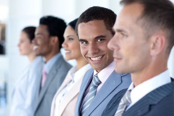 Handsome leadership in a row with his team — Stock Photo, Image