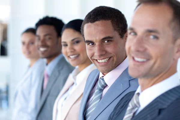 Attractive businessman in a row with his team — Stock Photo, Image