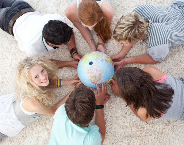 High angle of teenagers on the floor examining a terrestrial wor — Stock Photo, Image