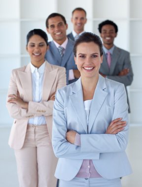 Businesswoman with her team smiling at the camera clipart