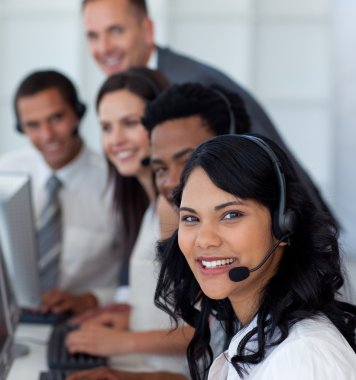 Portrait of a businesswoman in a call center with her team clipart