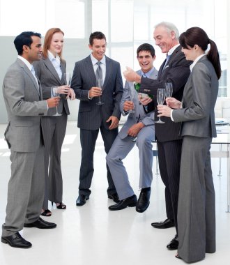 Senior manager opening a bottle of Champagne to celebrate a succ clipart